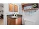 Elegant bathroom featuring granite countertops, wood cabinetry, and coordinated fixtures at 1565 Monarch Dr, Venice, FL 34293