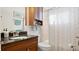 Clean bathroom with single vanity, granite countertop and shower/tub combo at 1565 Monarch Dr, Venice, FL 34293