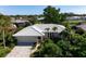 Single-story home with tile roof, landscaped yard, and paved driveway at 1745 S Gondola Ct, Venice, FL 34293