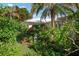 Landscaped garden with tropical plants and flowers near the house at 1745 S Gondola Ct, Venice, FL 34293