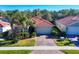 Single-Gathering home with a driveway and a lush green lawn at 19348 Yellowtail Ct, Venice, FL 34292