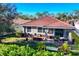 Aerial view of a house with a backyard and patio area at 19348 Yellowtail Ct, Venice, FL 34292
