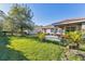 Green grassy backyard with a white swing and surrounding trees at 19348 Yellowtail Ct, Venice, FL 34292