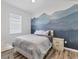 Bedroom with mountain mural and wood flooring at 19348 Yellowtail Ct, Venice, FL 34292
