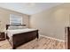 Spacious bedroom with a large bed, dresser, and wood flooring at 19348 Yellowtail Ct, Venice, FL 34292