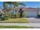 Attractive one-story home with a tile roof, landscaping, and a two-car garage at 19348 Yellowtail Ct, Venice, FL 34292