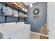 Laundry room with washer, dryer, shelving and stylish wall decor at 19348 Yellowtail Ct, Venice, FL 34292