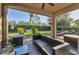 Covered patio with wicker furniture and a view of the backyard at 19348 Yellowtail Ct, Venice, FL 34292