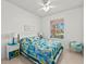 Cozy bedroom with a blue and green quilt, and a view of the backyard at 19397 Rizzuto St, Venice, FL 34293