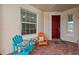 Covered porch with colorful chairs and a welcome mat at 19397 Rizzuto St, Venice, FL 34293