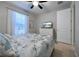 Bedroom with a queen bed, TV, and ceiling fan at 19764 Ortona St, Venice, FL 34293