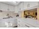 White kitchen with quartz countertops, offering view into living room at 200 Park N Blvd # 104, Venice, FL 34285