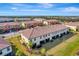 Aerial view of townhomes, showcasing community layout and lake at 20428 Lagente Cir, Venice, FL 34293