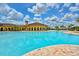 Large community pool with a stylish clubhouse and ample space for relaxation at 20460 Granlago Dr, Venice, FL 34293