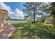 Large backyard with patio and mature tree at 225 Firenze W Ave, Venice, FL 34285