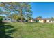 Spacious backyard featuring a large tree and shed at 225 Firenze W Ave, Venice, FL 34285