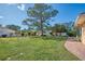 Large backyard with spacious lawn, shed, and patio at 225 Firenze W Ave, Venice, FL 34285