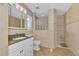 Updated bathroom with walk-in shower and granite vanity at 225 Firenze W Ave, Venice, FL 34285