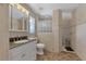 Updated bathroom with walk-in shower and granite vanity at 225 Firenze W Ave, Venice, FL 34285