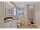 Updated bathroom with walk-in shower and granite vanity at 225 Firenze W Ave, Venice, FL 34285