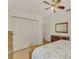 Bright bedroom with a ceiling fan, large closet, and dresser at 225 Firenze W Ave, Venice, FL 34285