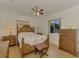 Comfortable bedroom with wooden furniture and ceiling fan at 225 Firenze W Ave, Venice, FL 34285
