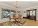 Bright dining room with hardwood floors and large windows at 225 Firenze W Ave, Venice, FL 34285