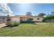 House exterior with well-maintained lawn and brick driveway at 225 Firenze W Ave, Venice, FL 34285