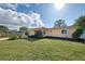 Front view of a ranch-style home showcasing its landscaping and lawn at 225 Firenze W Ave, Venice, FL 34285