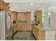 Modern kitchen with granite countertops and wood cabinets at 225 Firenze W Ave, Venice, FL 34285