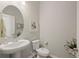 Small powder room with pedestal sink and toilet at 228 Daylily Blvd, Nokomis, FL 34275