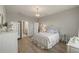 Bright bedroom with white metal bed frame and ensuite bathroom at 228 Daylily Blvd, Nokomis, FL 34275