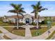 Community clubhouse with palm trees and entrance at 228 Daylily Blvd, Nokomis, FL 34275