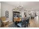 Dining area with wood table, chandelier, and kitchen view at 228 Daylily Blvd, Nokomis, FL 34275