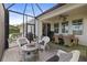 Spacious screened patio with dining area, seating, and fire pit at 228 Daylily Blvd, Nokomis, FL 34275