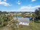 Aerial view of a single-story home near a pond with lush landscaping at 2281 Mars Rd, Venice, FL 34293