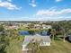 Aerial view of a single-story home near a pond with lush landscaping at 2281 Mars Rd, Venice, FL 34293