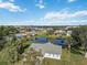 Aerial view of a single-story home near a pond with lush landscaping at 2281 Mars Rd, Venice, FL 34293