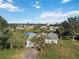 Single-story home on a tree-lined street, near a pond at 2281 Mars Rd, Venice, FL 34293