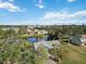 Aerial view of a single-story home near a pond with lush landscaping at 2281 Mars Rd, Venice, FL 34293