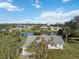 Single-story home on a tree-lined street, near a pond at 2281 Mars Rd, Venice, FL 34293