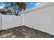 Small backyard with concrete patio and white fence at 2281 Mars Rd, Venice, FL 34293