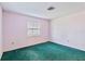 Small bedroom with teal carpet and one window at 2281 Mars Rd, Venice, FL 34293