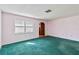 Spacious bedroom with teal carpet and a window with shutters at 2281 Mars Rd, Venice, FL 34293