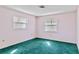 Spacious bedroom with teal carpet and multiple windows at 2281 Mars Rd, Venice, FL 34293
