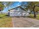 Single story home with attached garage and a tree in the front yard at 2281 Mars Rd, Venice, FL 34293