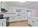 Kitchen with white cabinets and black appliances at 2281 Mars Rd, Venice, FL 34293