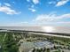 Aerial view of tennis courts and basketball court by the water at 2281 Mars Rd, Venice, FL 34293