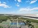 Aerial view of tennis courts and basketball court by the water at 2281 Mars Rd, Venice, FL 34293