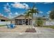 Screened patio, fire pit, and palm trees at 23102 Madelyn Ave, Port Charlotte, FL 33954